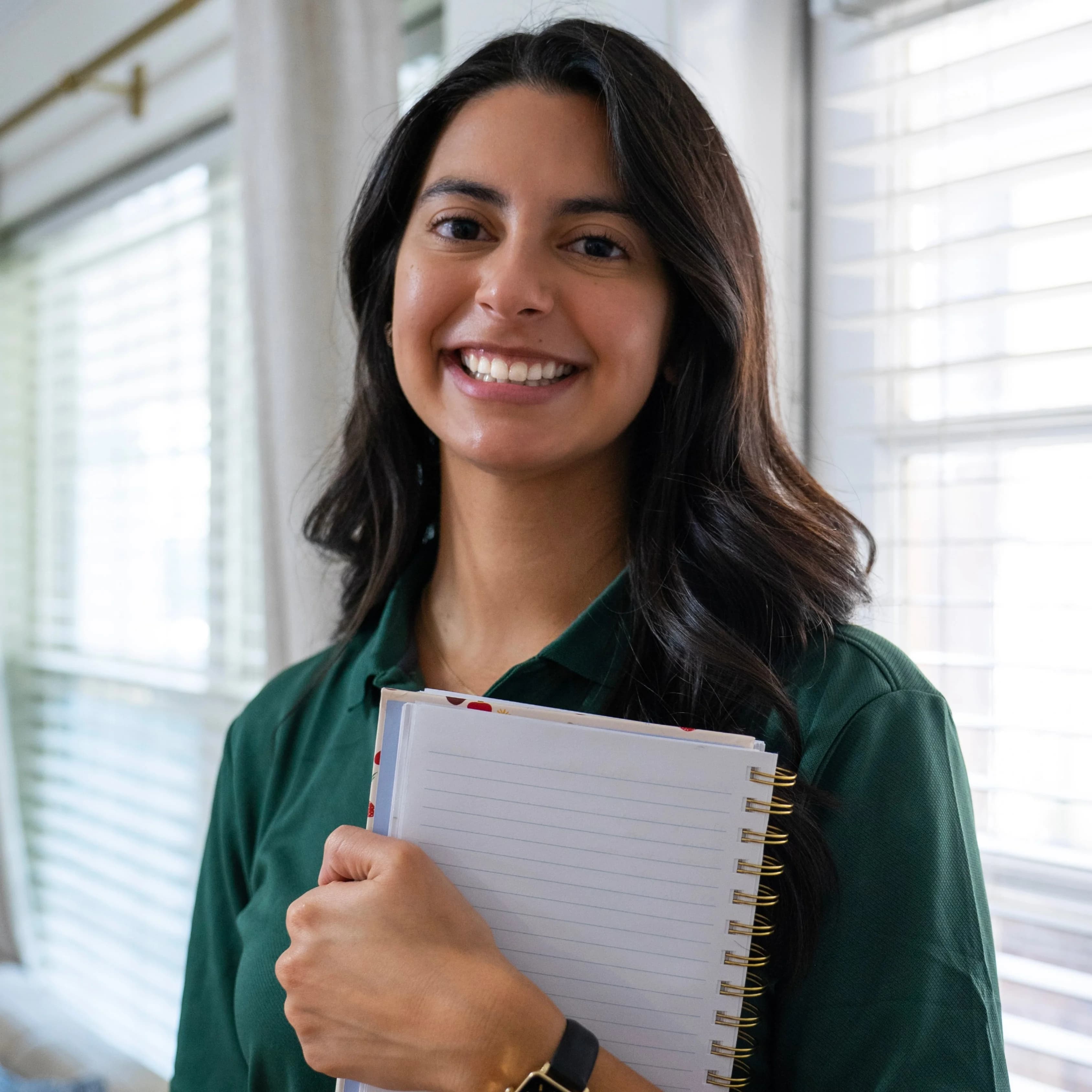 Karen, owner of Silvia's Cleaning, smiling and holding a notebook